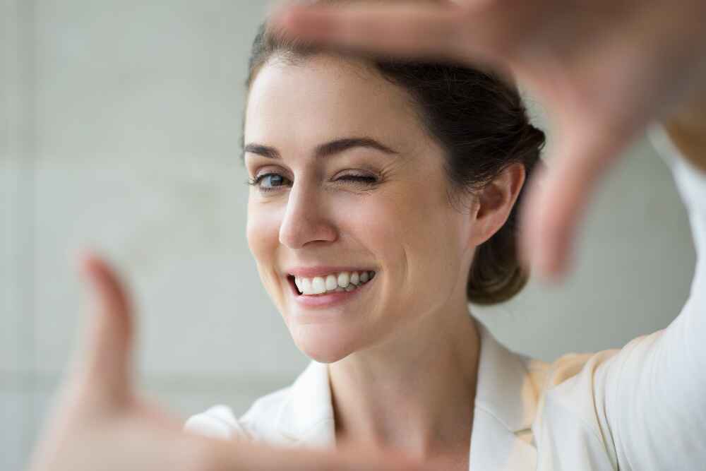 Close-up of a smiling person with newly created dimples