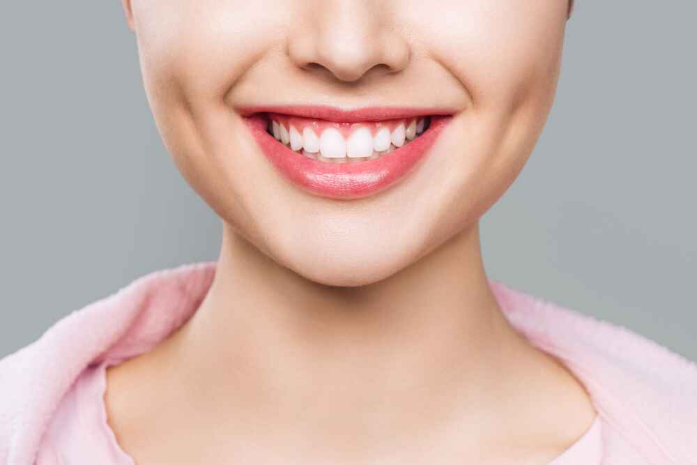 Close-up of a smiling face with prominent dimples